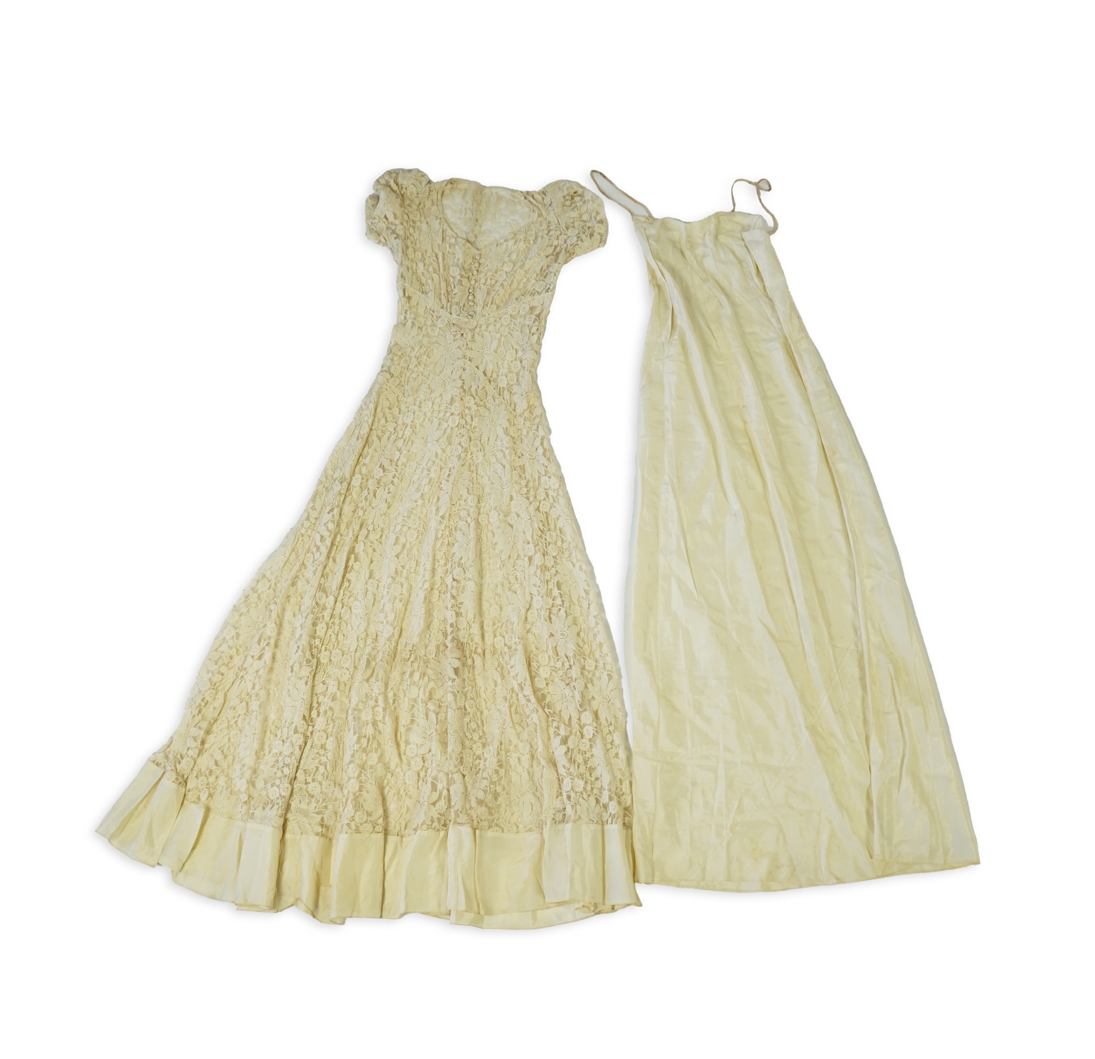 An early 1940's cream cotton lace and taffeta evening dress, with matching taffeta petticoat, possibly worn as a wedding dress., Dress 144cm long. Condition - minor repairs needed to lace in places and laundering to remo